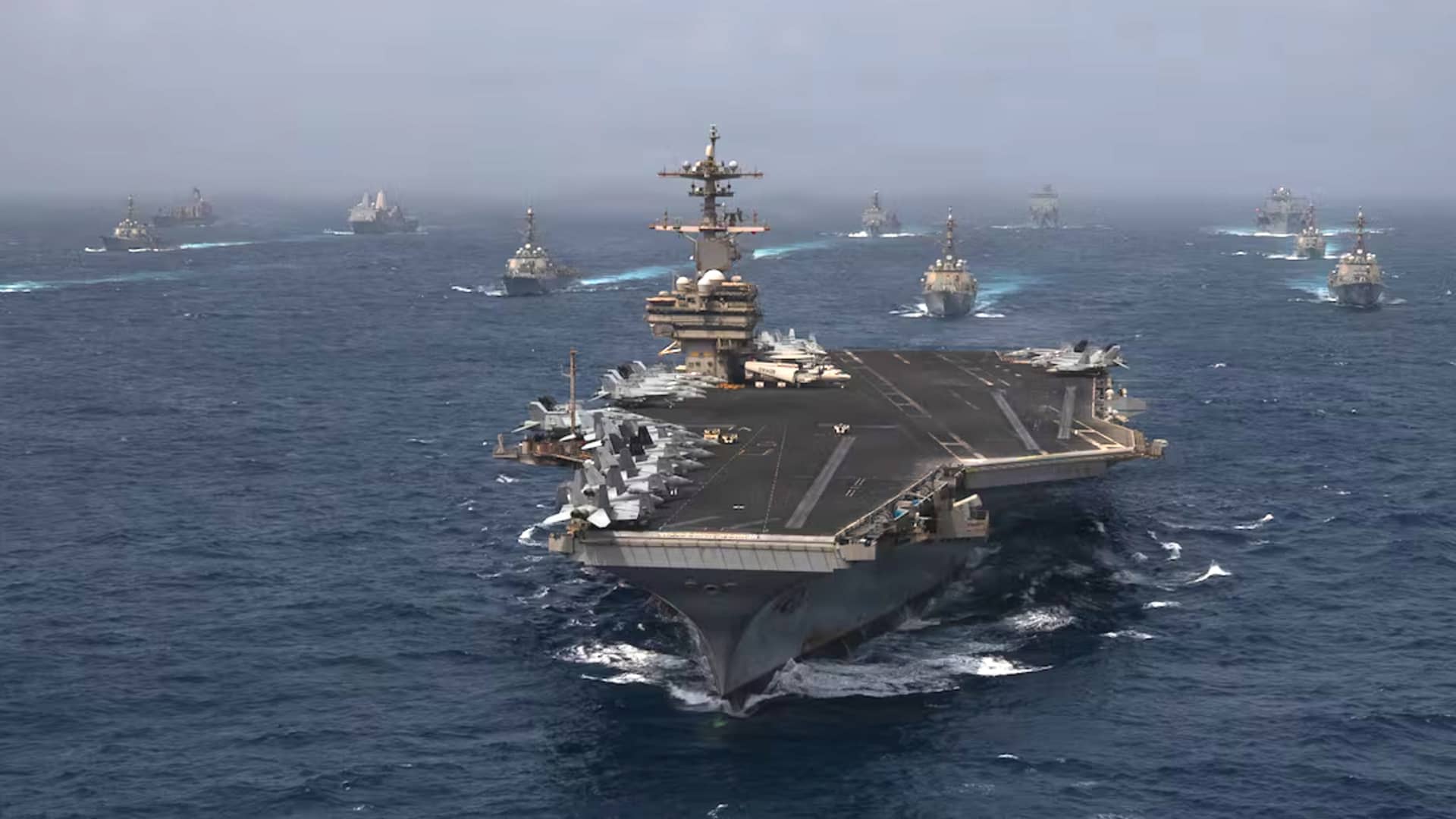 美国海军舰艇在阿曼湾执行对伊封锁任务,海面可见油轮,呼应文中关于霍尔木兹海峡流量腰斩的讨论